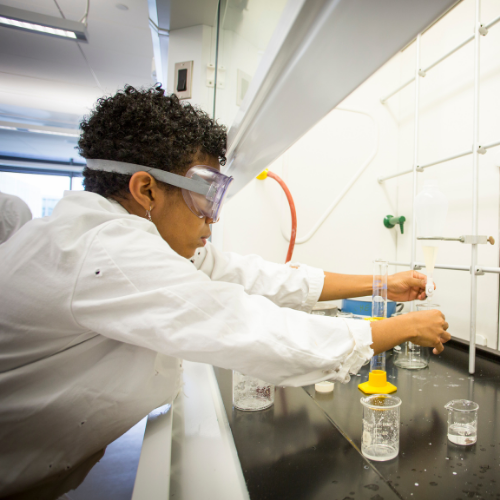 Student working under fume hood.